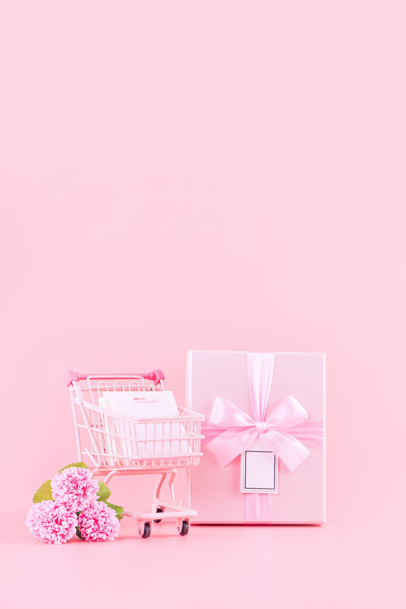 Carnation Flower, Gift Box, and Tiny Cart on Color Background