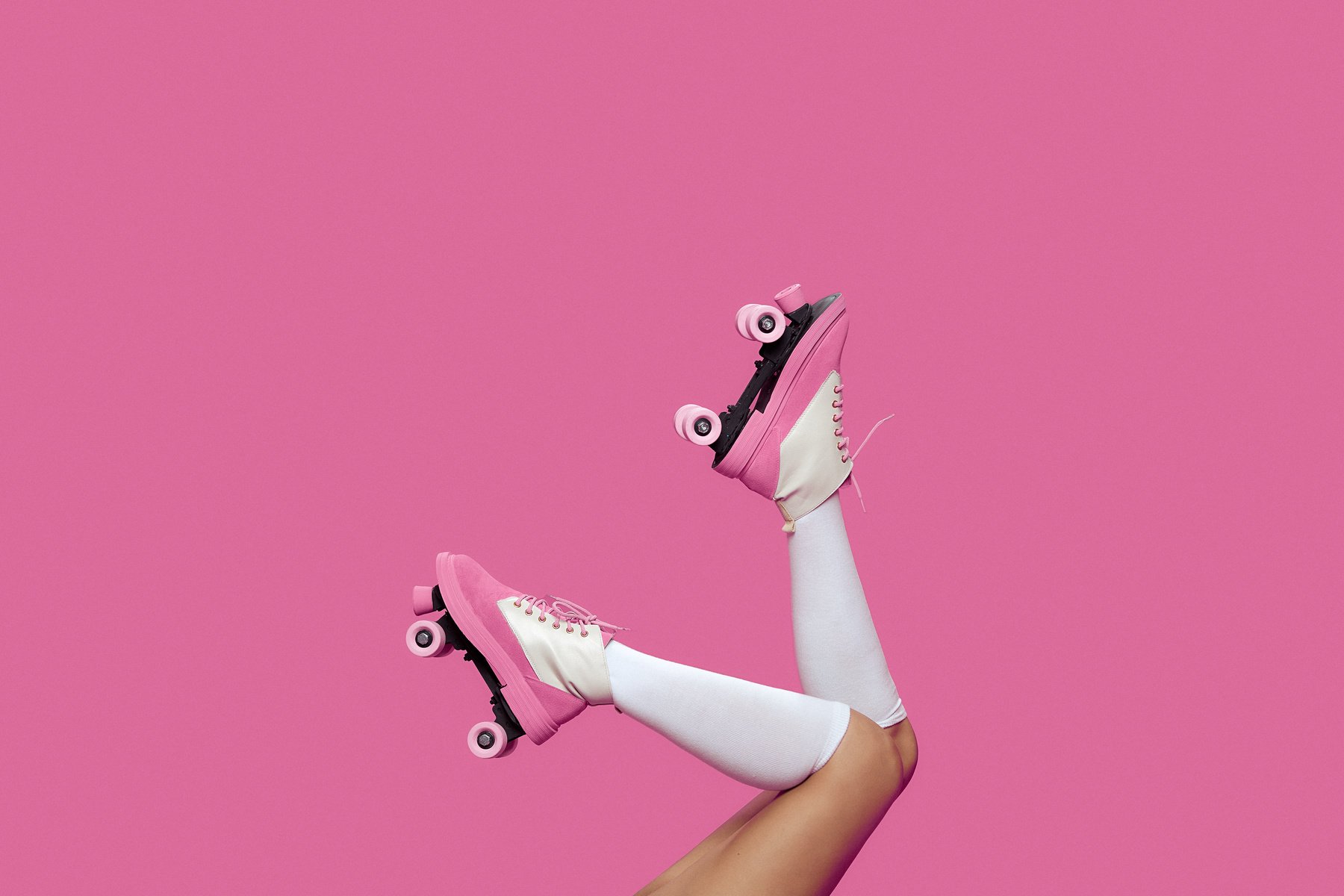 Person Wearing Pink Roller Skates